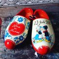 Hand-painted wooden shoes with flowers and kissing farmer and farmer's wife, personal wedding gift with name